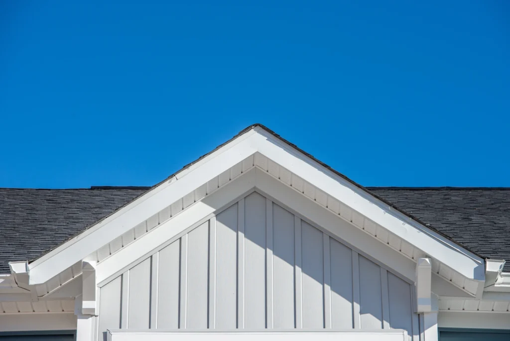 close up of gable roof with new vertical siding installation