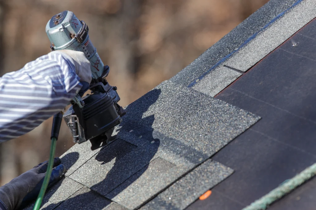 close up of roofing contractor fixing roof leak on residential home