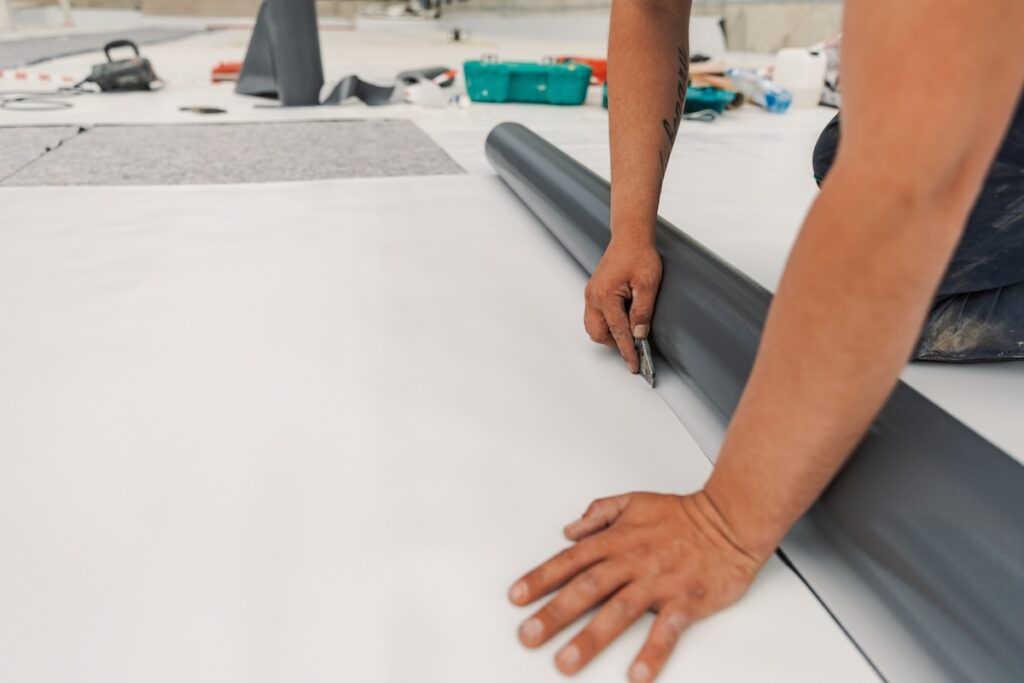 Worker specialized in mounting TPO membranes, TPO in the process of installing a water resistant