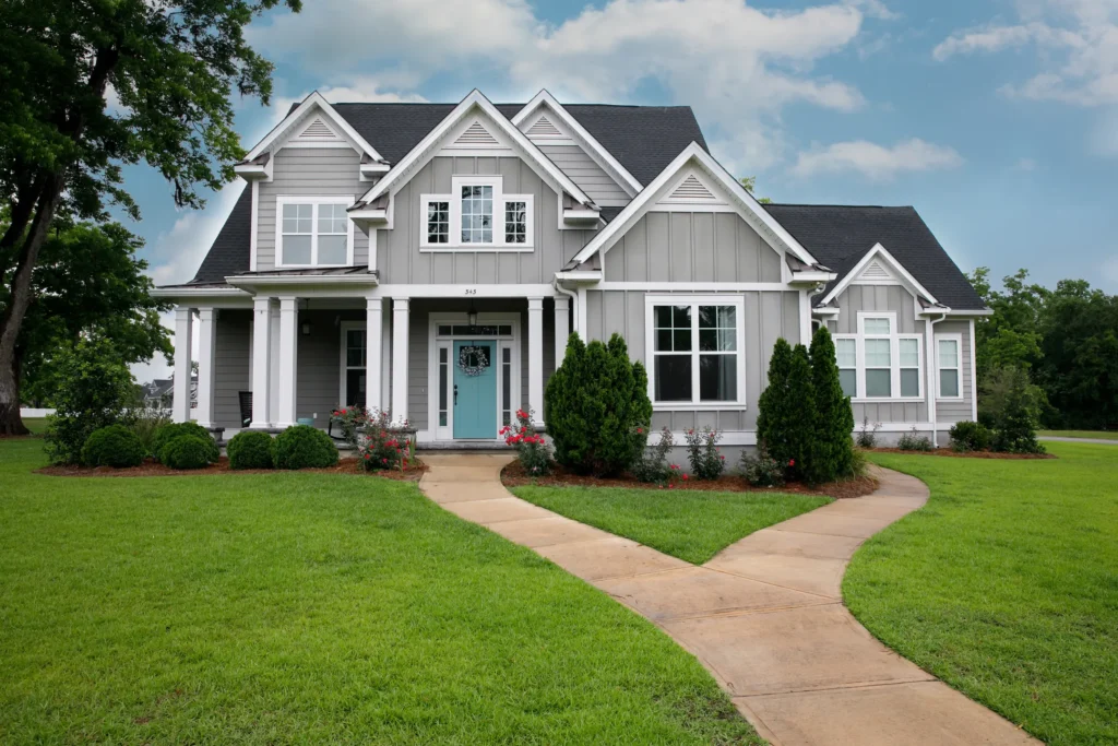 Light gray house with a dark gray roof and a blue door in Elk River