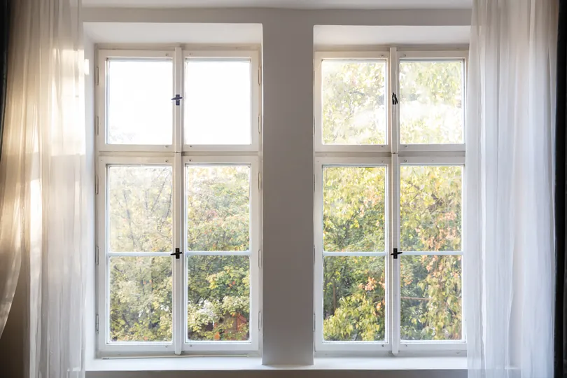 New windows with white curtains in Maple Grove