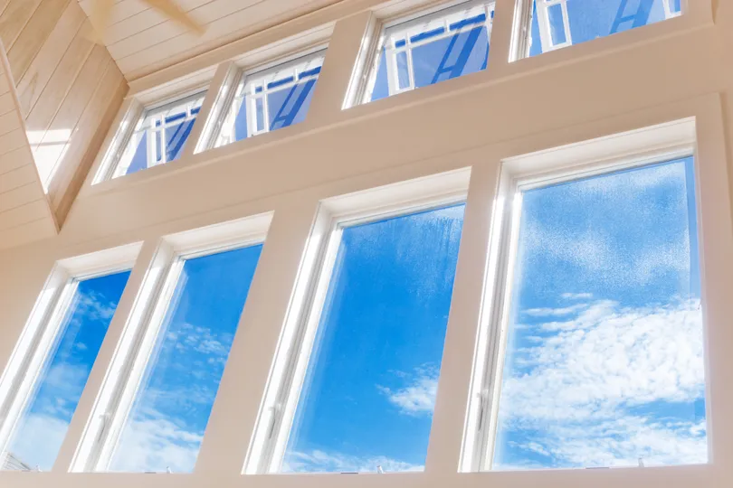 Newly installed white windows with a blue sky outside in Minneapolis