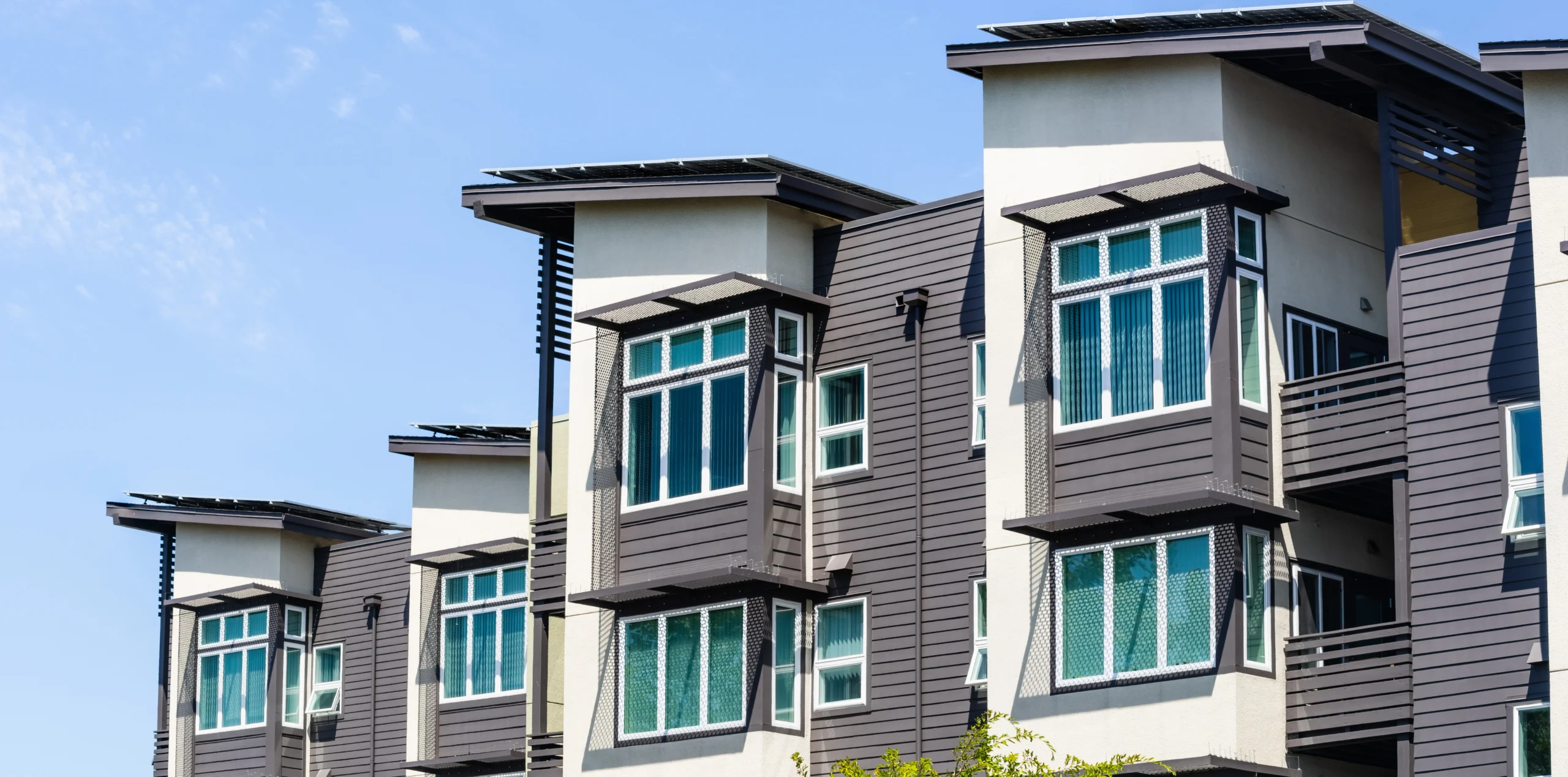 grey and white apartments with windows