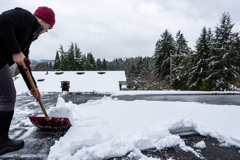shoveling snow off of flat roof