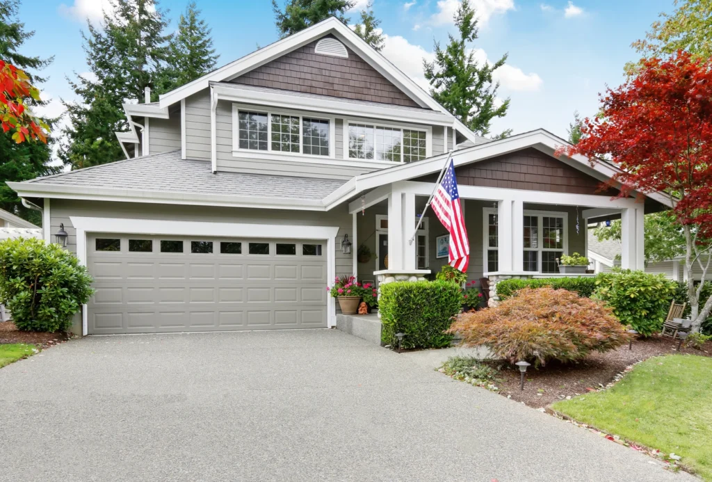 Shingle roof installation on st cloud home with pine trees and american flag in yard