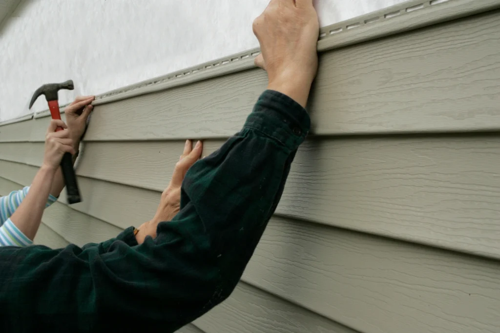 close up view of siding contractor working on excelsior home
