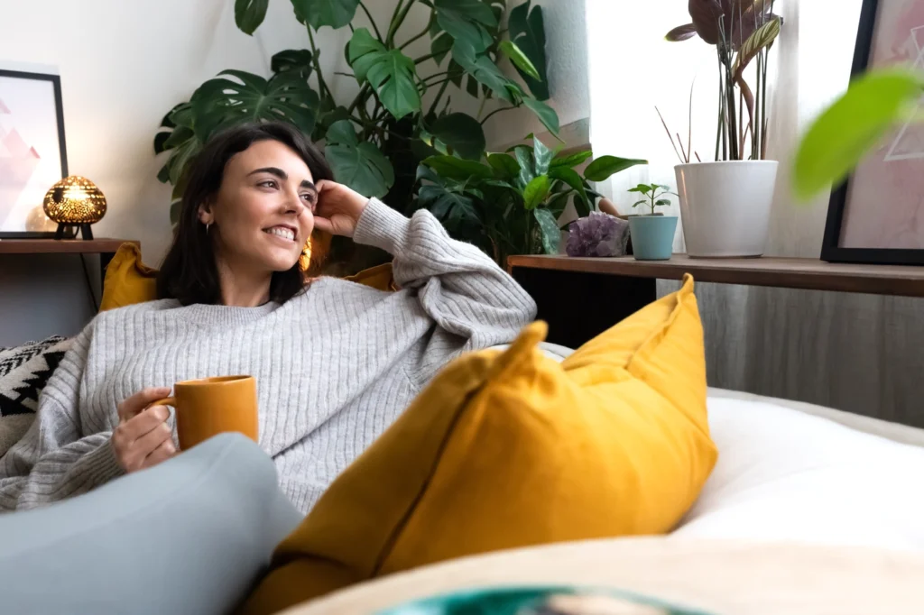 young homeowner in rogers mn drinking coffee on the couch