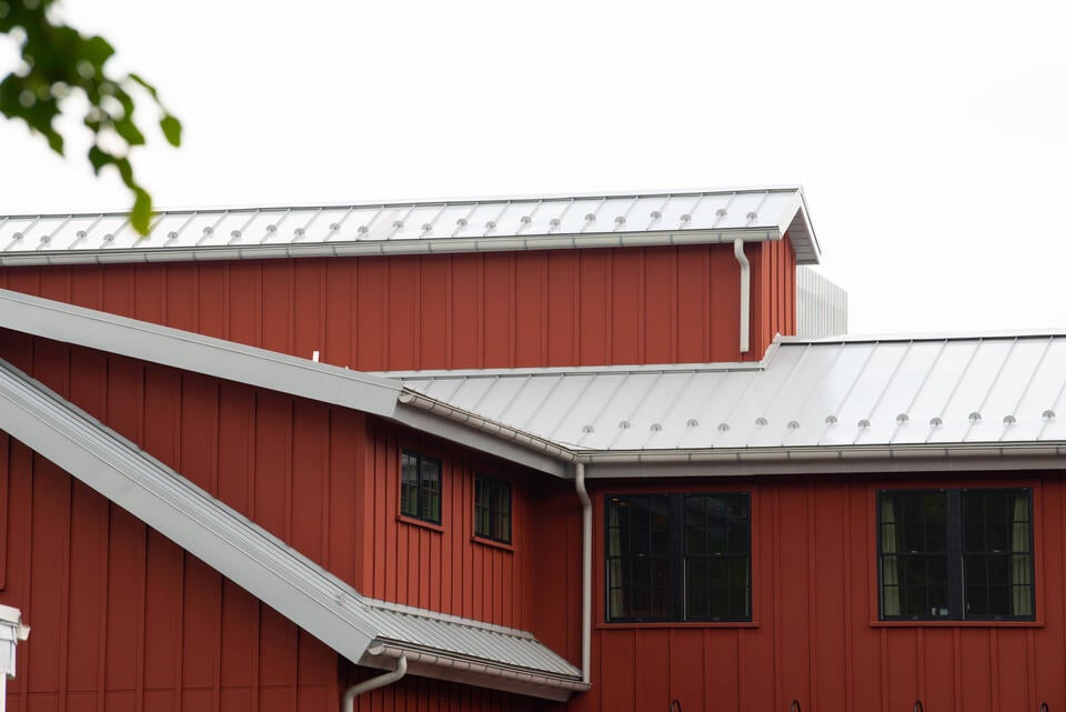 how to install snow guards on metal roof-red metal home with white metal standing seam roof that has snow guards installed