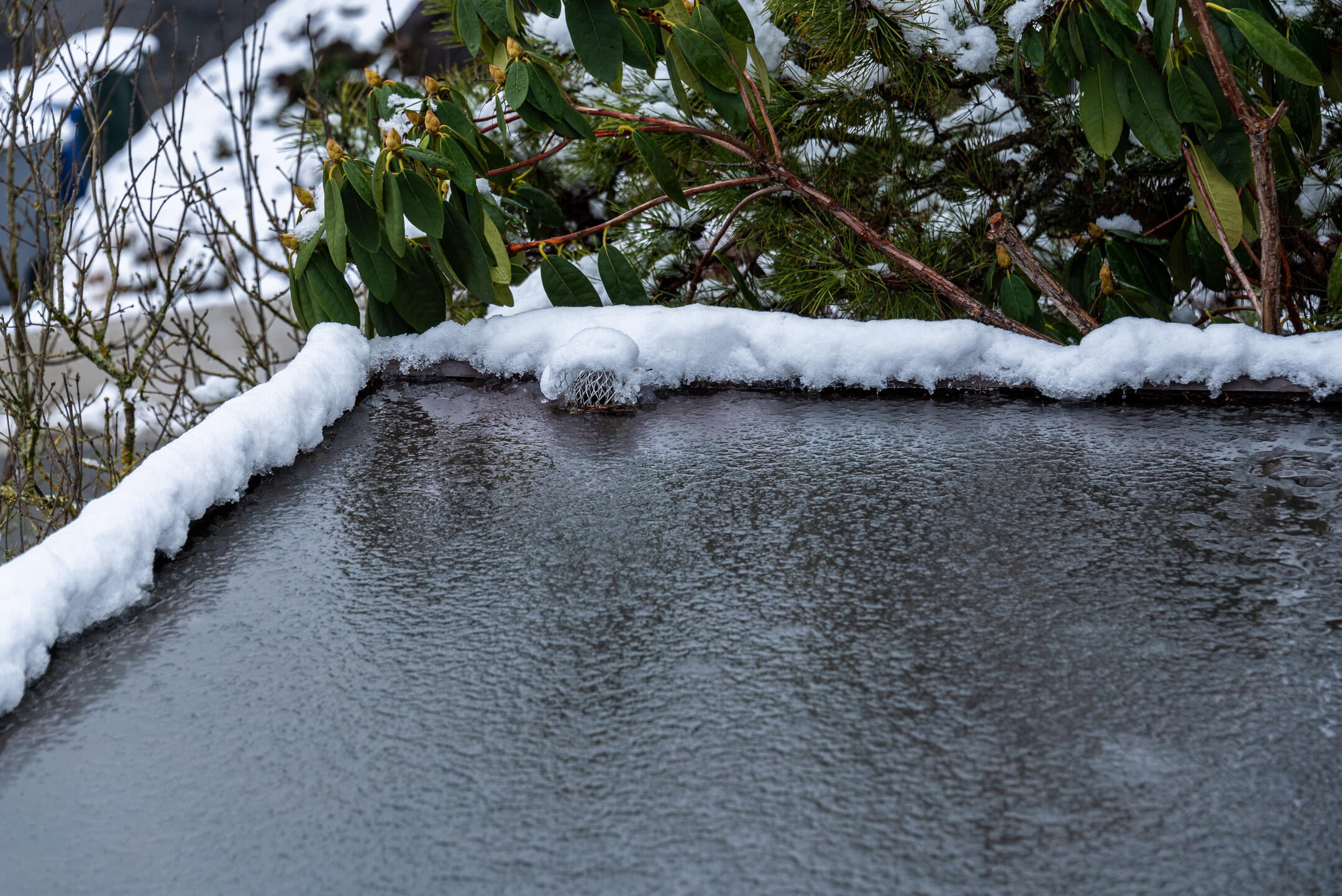 how to prevent ice buildup on a flat roof-close up of flat roof covered in ice