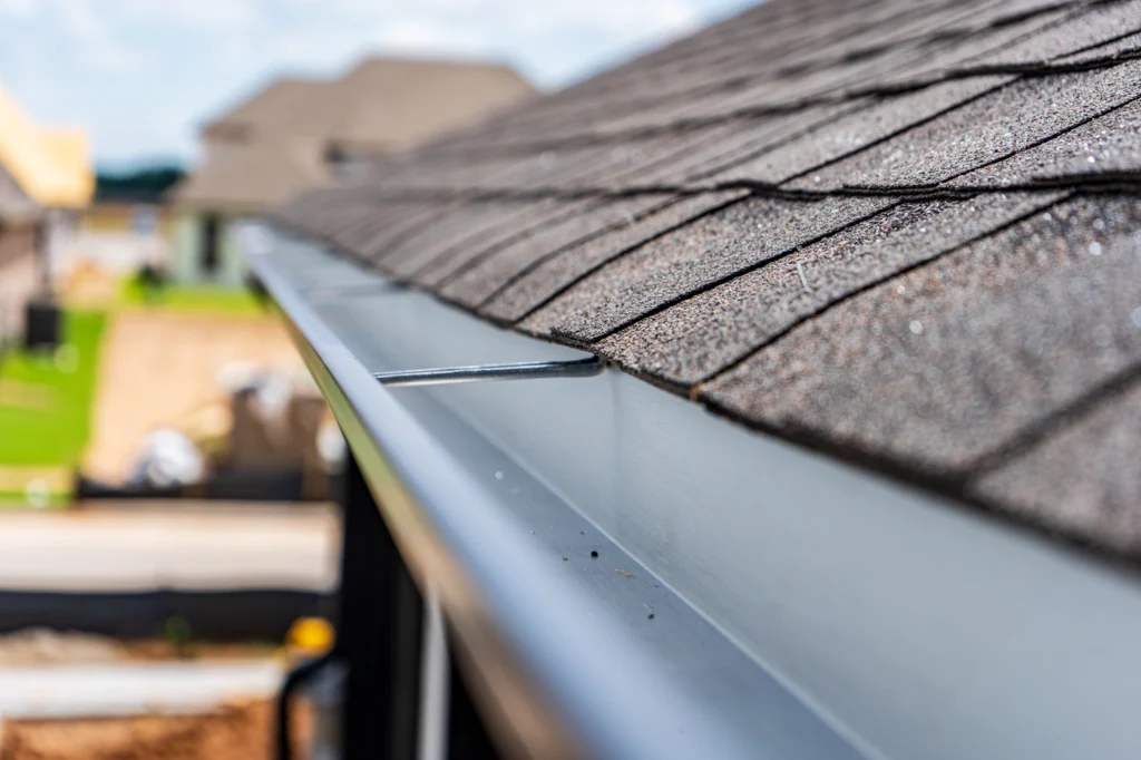 shingle roofing system with new gutter installation