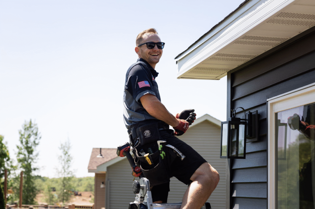 Northface employee smiling working on siding