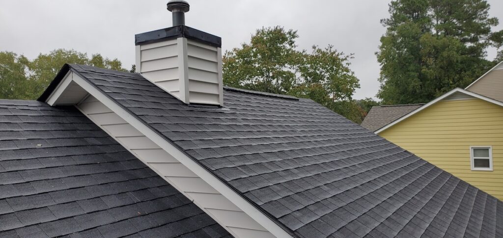 New black roof on a white house