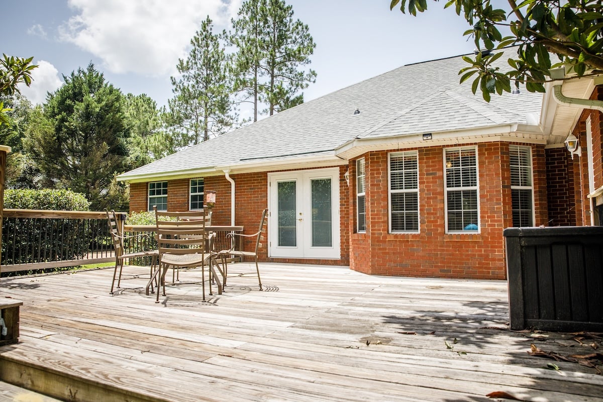 Back rear View Side of Traditional red brick home and expansive yard lot